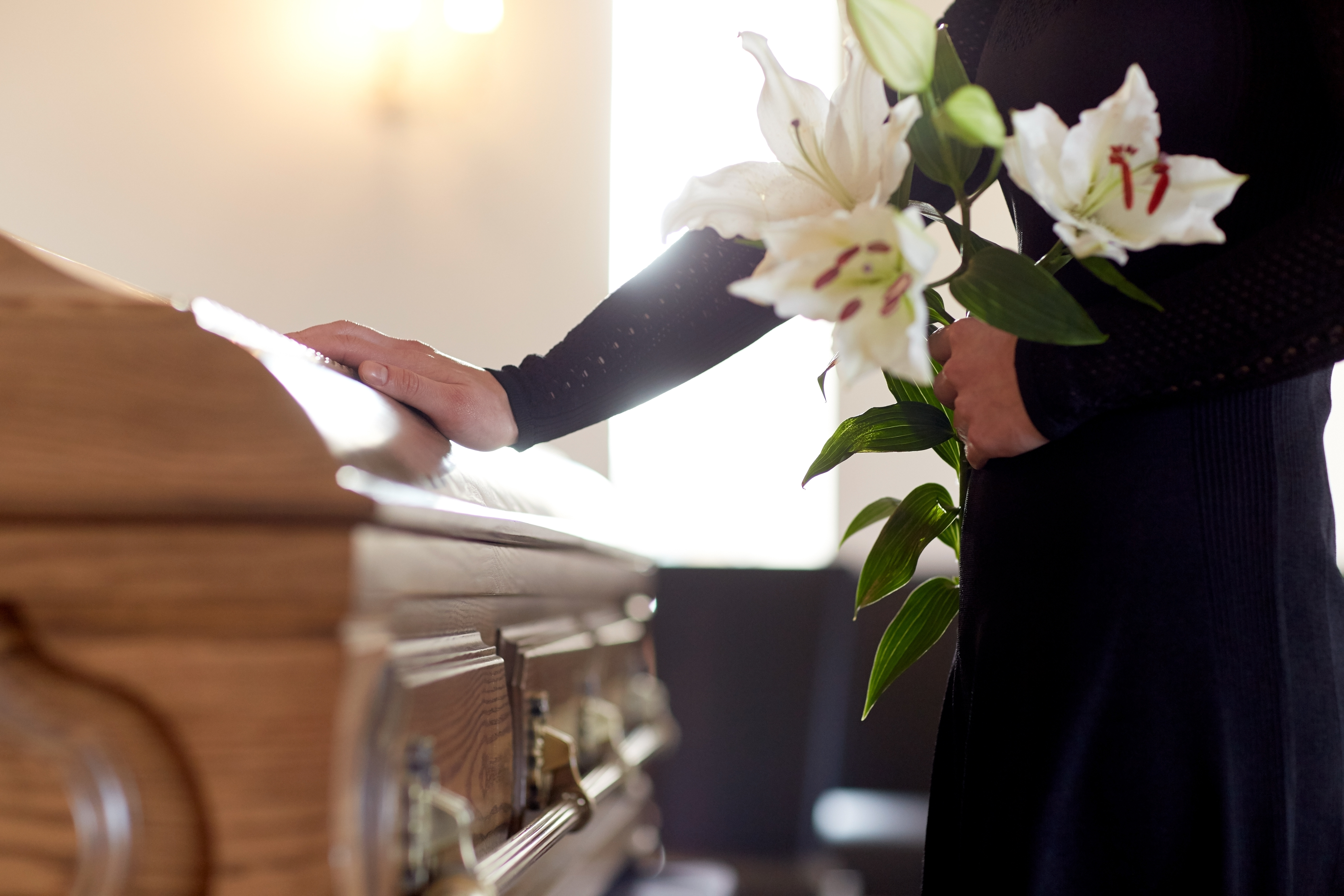 white lily flowers and coffin at funeral in church