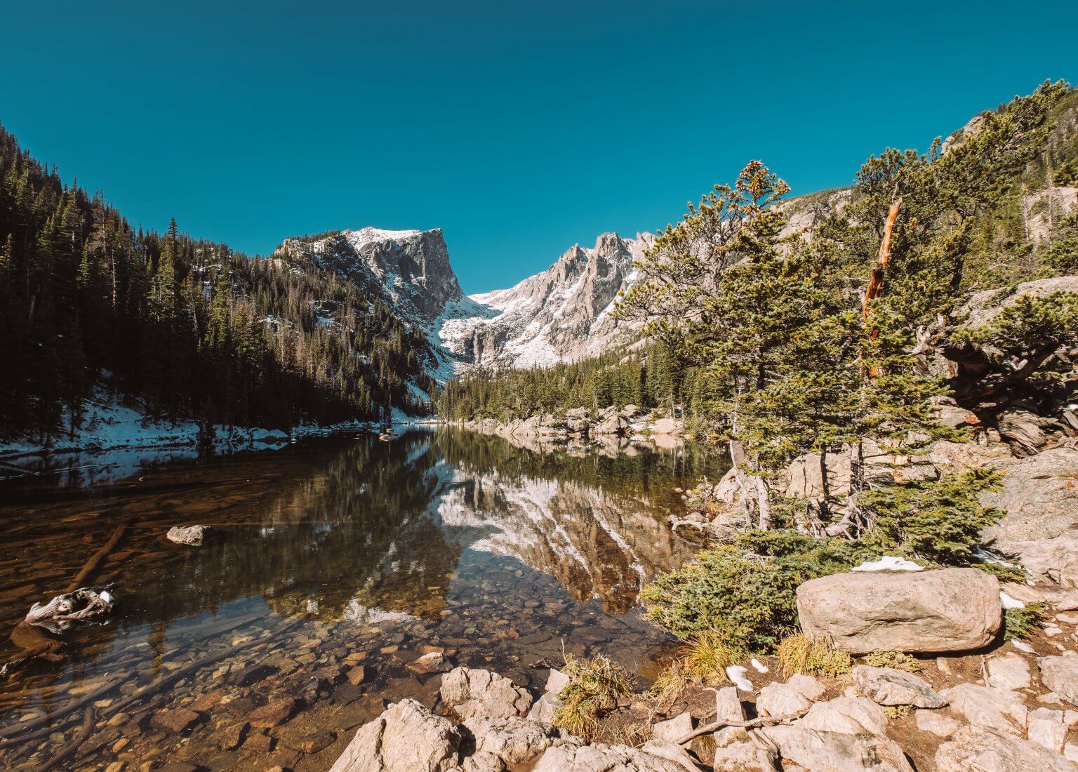 Dream Lake and reflection with mountains in snow around at autumn. Rocky Mountain National Park in Colorado, USA.