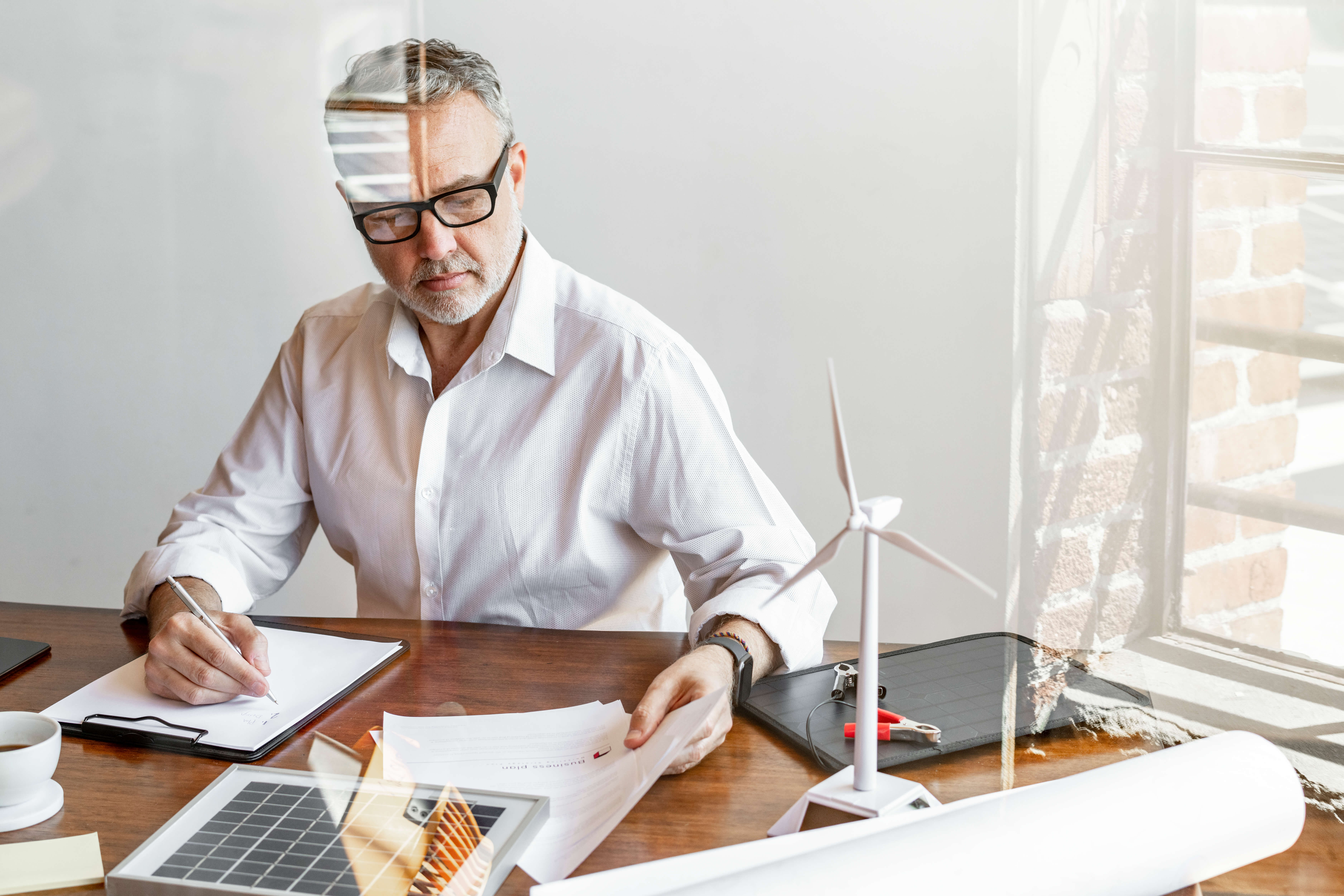 Man planning renewable energy projects at desk